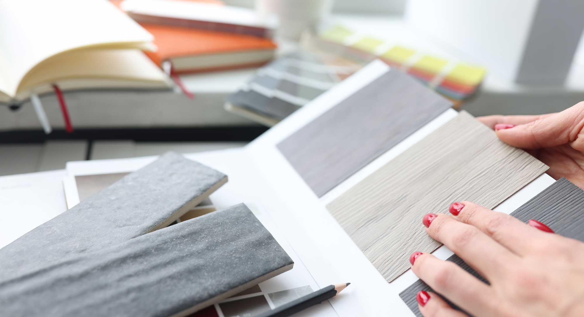 Woman choosing color of laminate board in design studio